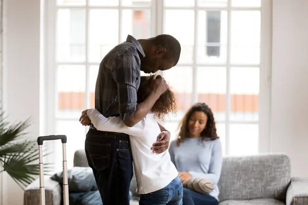 Sad African American girl hug dad leaving home with suitcase — Stock Photo, Image
