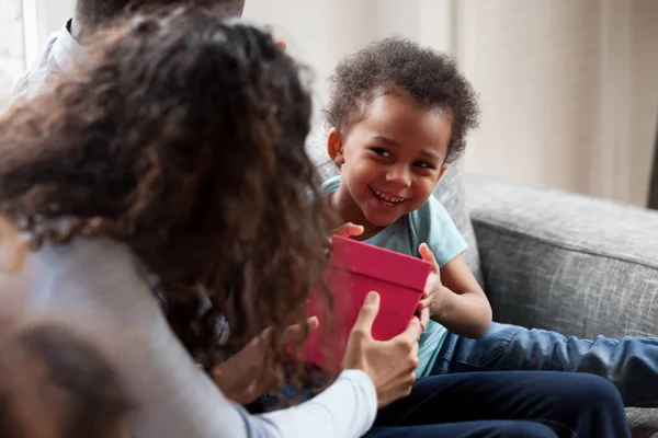 Funny black toddler give box making present to mom — Stock Photo, Image