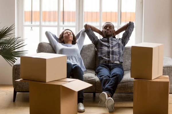 Black young couple relax on couch tired on moving day — Stock Photo, Image