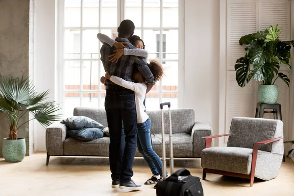 Happy African American family hug welcoming dad home — Stock Photo, Image