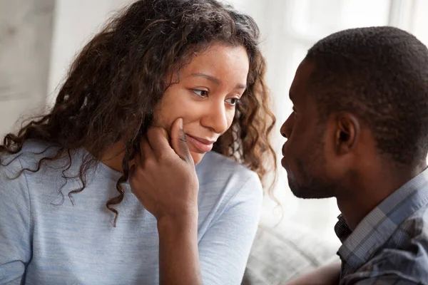 Loving black man cheering sad young girlfriend — Stock Photo, Image