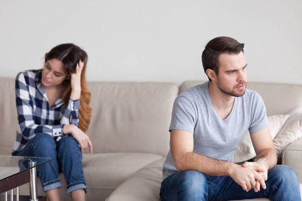 Sad angry husband ignoring avoiding talk to cheating bad wife