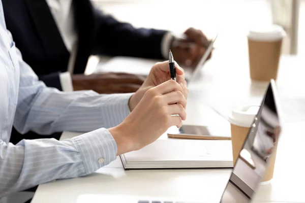 Closeup diverse businesspeople sitting at conference table listening to speaker — Stock Photo, Image