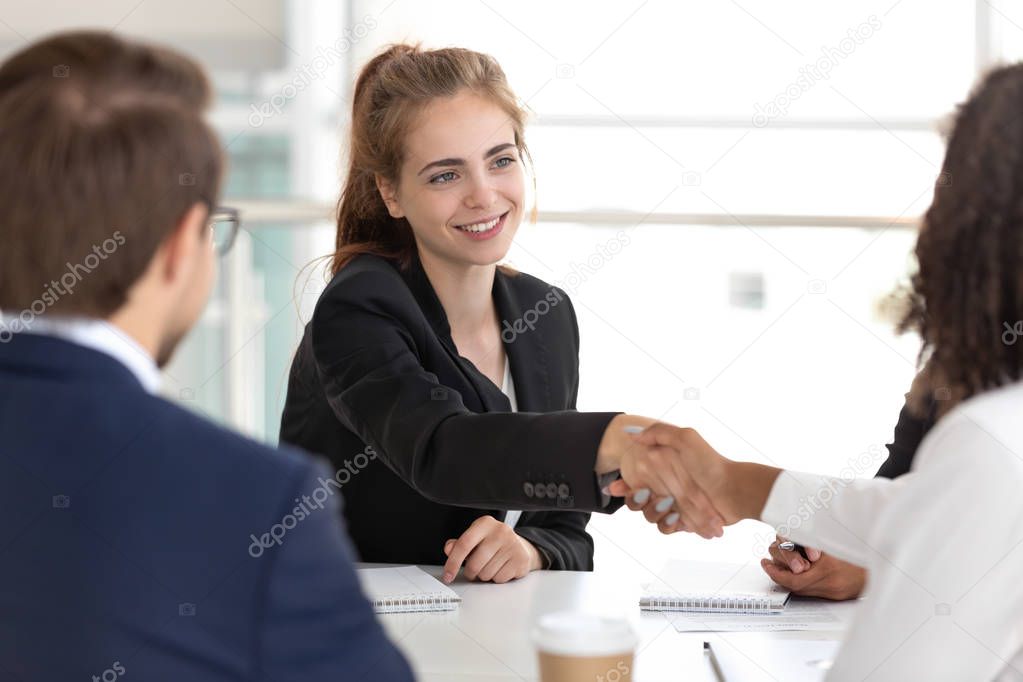 Businesspeople handshaking at the beginning of multinational negotiations