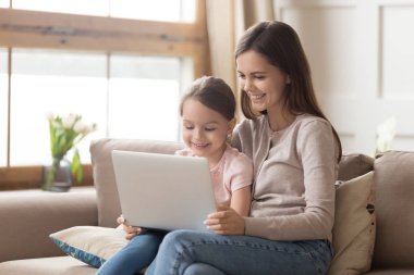 Mutlu anne ve çocuk kızı kullanma dizüstü bilgisayar vasıl ev