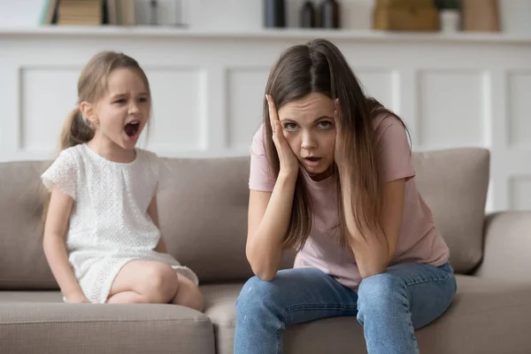 Stressed mother feeling desperate about screaming stubborn kid daughter tantrum — Stock Photo, Image