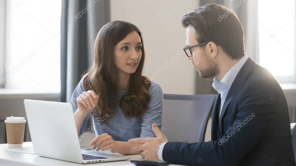 Female manager broker consulting client in corporate office with laptop