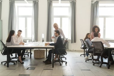 Modern office interior with business team people working on computers clipart
