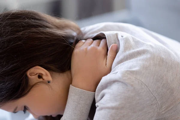 Close up young caucasian woman suffers from neck pain — Stock Photo, Image