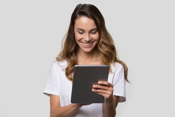 Woman using gadget looking at digital tablet screen studio shot — Stock Photo, Image