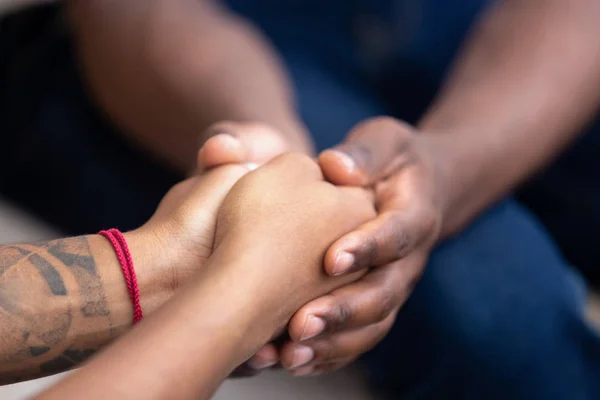 Black man friend holding hands of african woman, closeup view — Stock Photo, Image