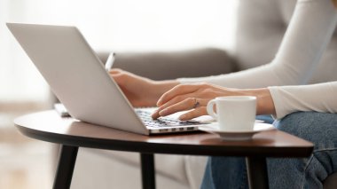 Evde laptop kullanarak kadın yakın yukarı, yazarak, notlar yazma