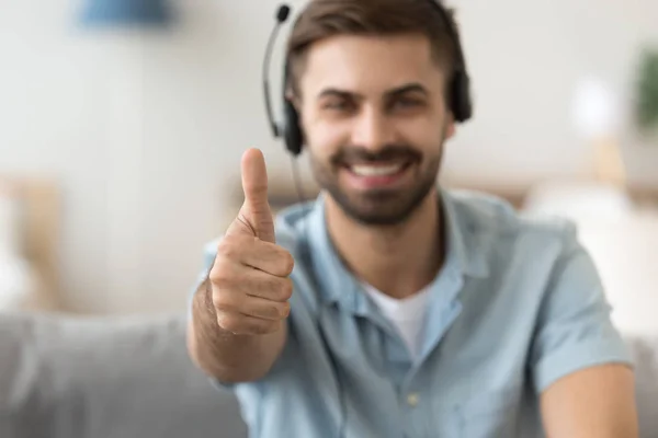 Close up satisfied man in headset showing thumbs up, approval — Stock Photo, Image