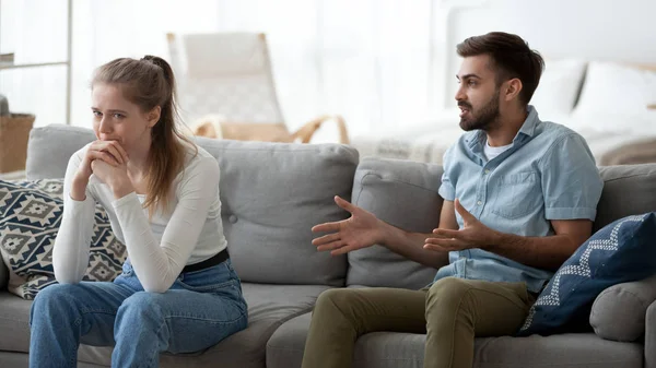 Angry man lecturing unhappy upset crying woman at home — Stock Photo, Image