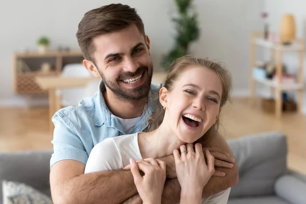 Head shot portrait of happy excited young couple in love at home — Stock Photo, Image