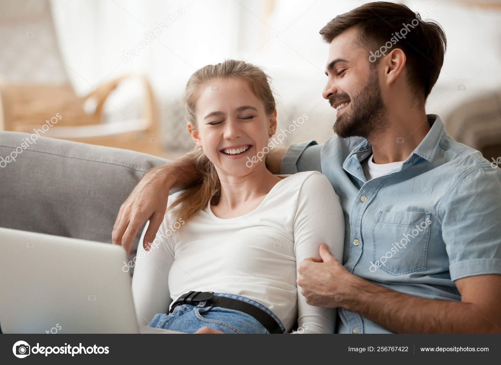Laughing Couple In Love Using Laptop Having Fun Together At Home
