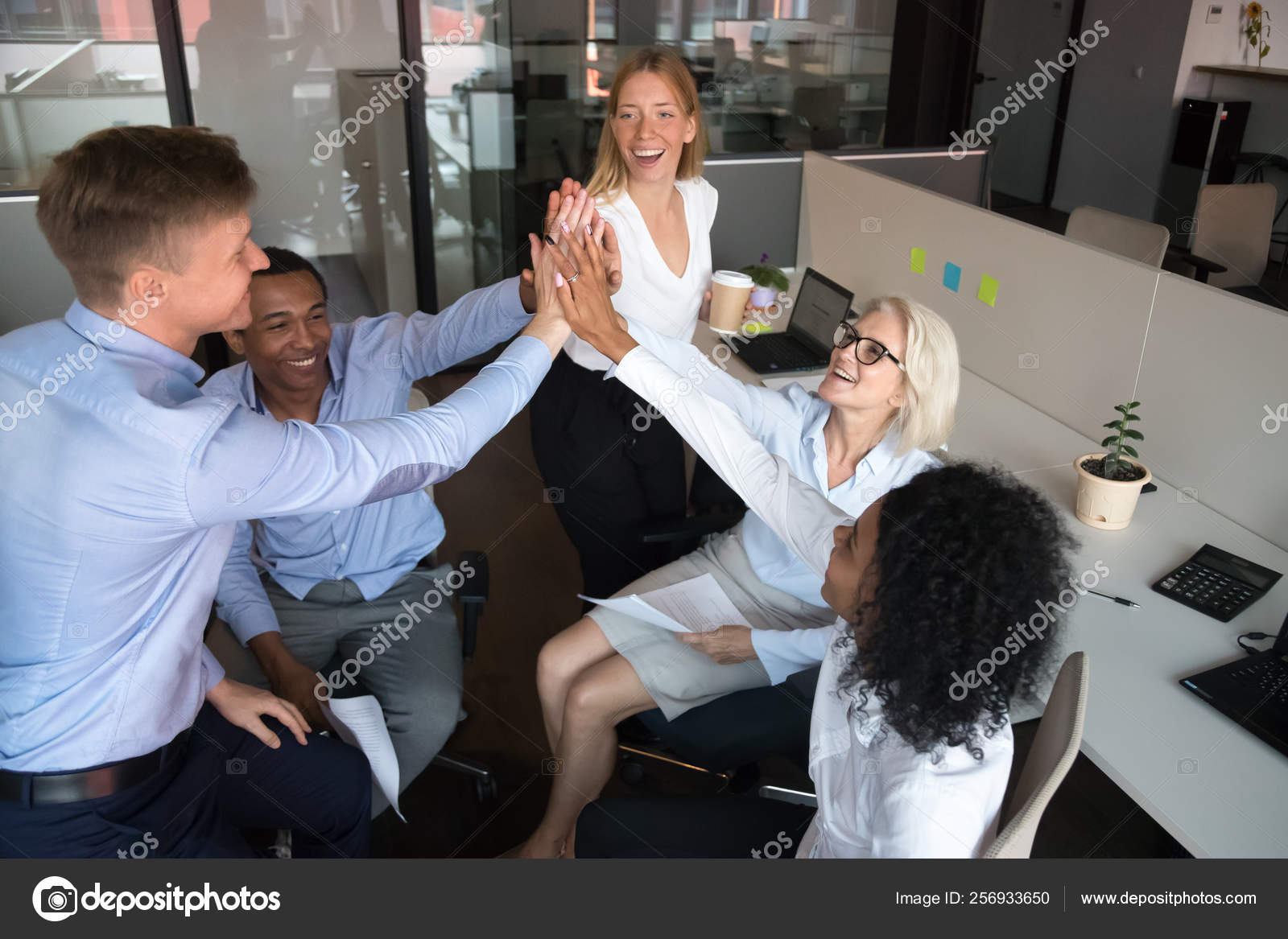 Happy diverse team workers of businesspeople give high five Stock Photo by ©fizkes 256933650