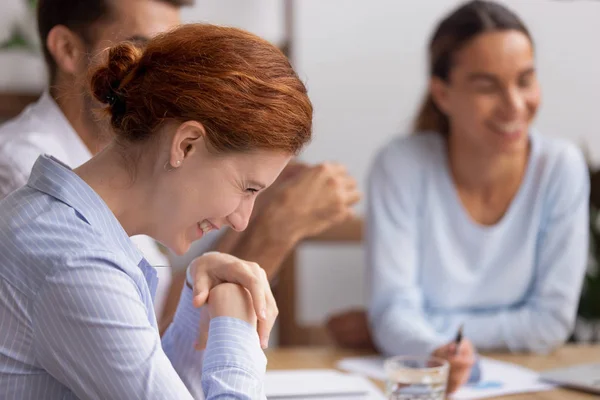 Happy cheerful businesswoman laughing at funny joke at group meeting — Stock Photo, Image