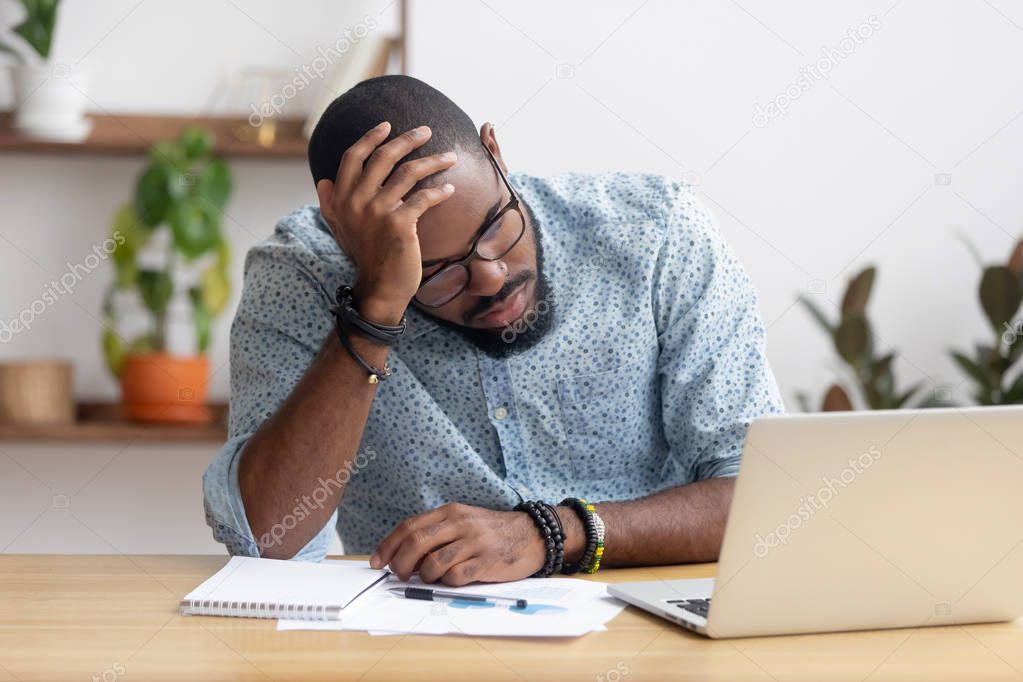 Tired depressed bored african businessman frustrated by business failure