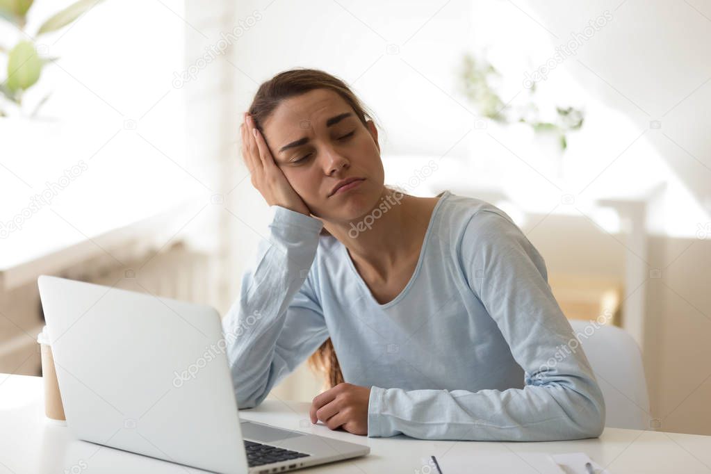 Tired woman sleeping at desktop in front of computer