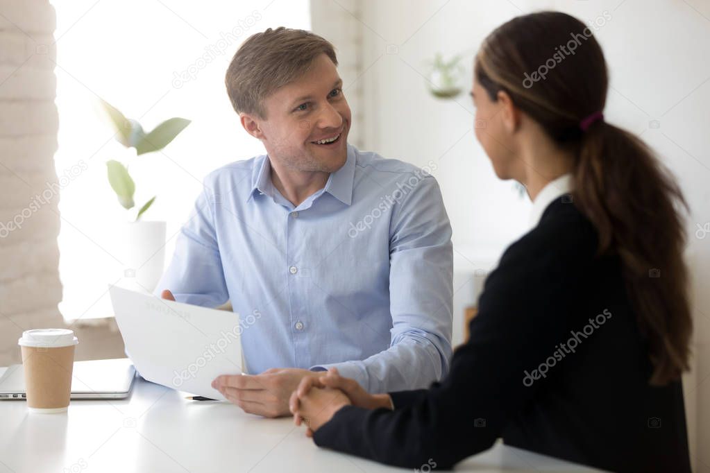 Funny employer and applicant laughing during successful job interview