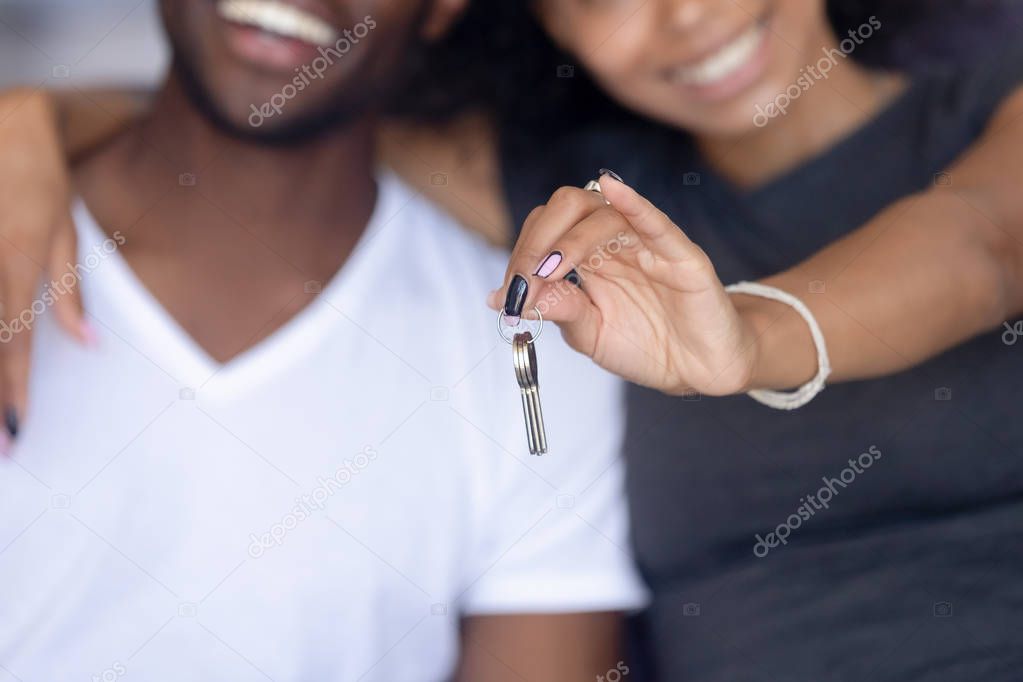Close up happy African American woman holding, embracing man