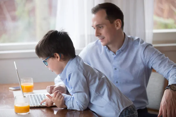 Father and son playing computer game on weekend at home — Stock Photo, Image