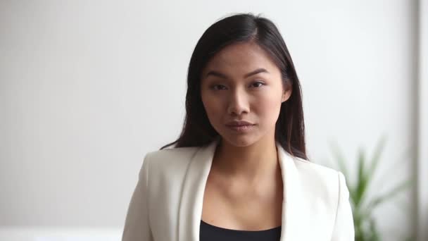 Young asian professional businesswoman looking at camera in office — Stock Video