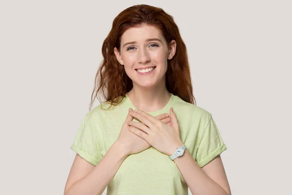 Grateful red-haired girl with hands on chest feel thankful — Stock Photo, Image