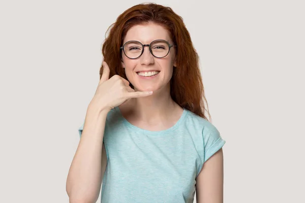 Smiling redhead girl in glasses show call phone gesture — Stock Photo, Image