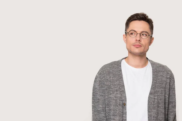 Homme caucasien douteux pensant isolé sur fond de studio gris — Photo