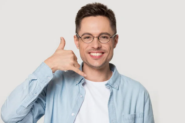 Smiling Caucasian man in glasses show call me gesture — Stock Photo, Image