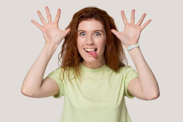 Smiling redhead girl play foolish showing funny faces — Stock Photo, Image