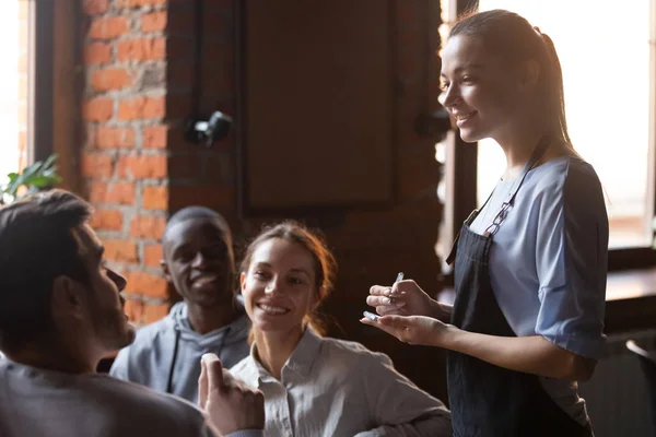 Diverse cheerful friends making order talking with waitress girl — Stock Photo, Image