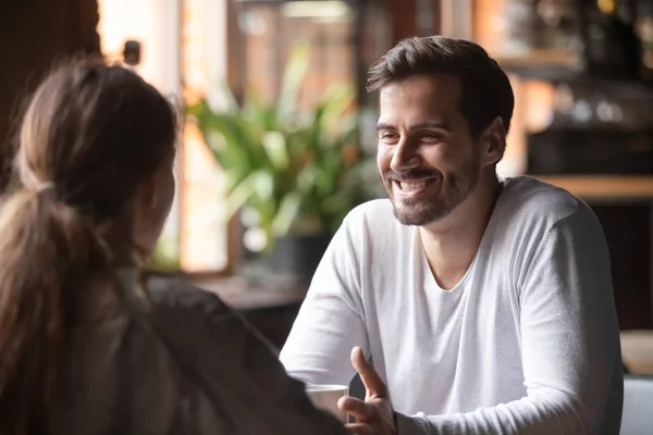 Vista trasera hembra sentada a velocidad citas con el hombre sonriente —  Fotos de Stock