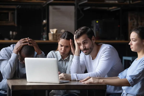 Disappointed football fans watching game on computer in public place — Stock Photo, Image