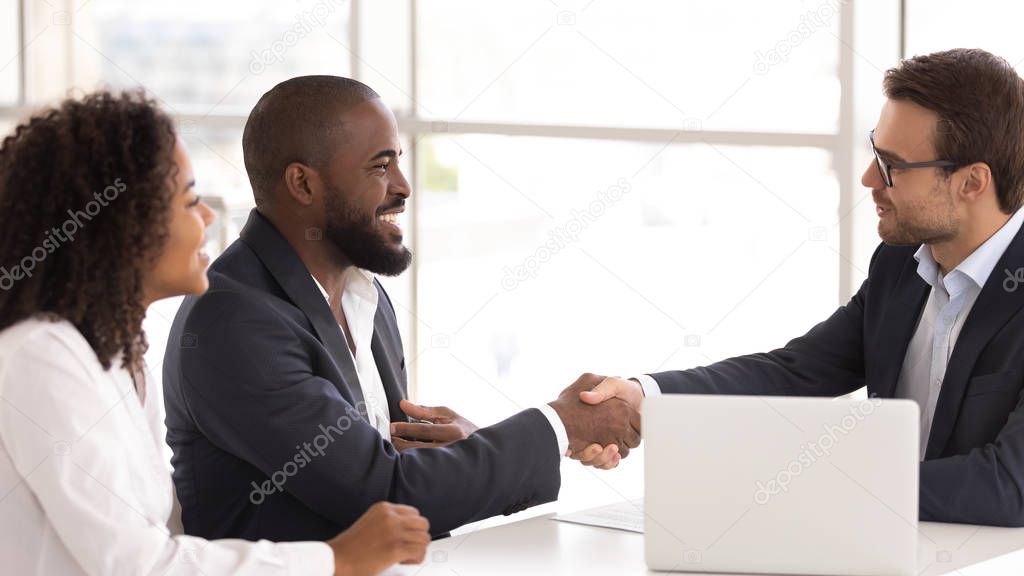 Happy african couple shake hand of insurer buy insurance services