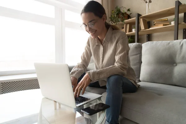 Mujer en gafas de trabajo escribiendo en el ordenador se siente satisfecho — Foto de Stock