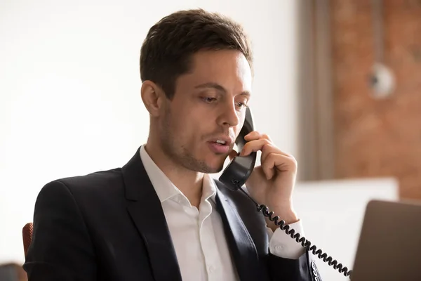 Close up of serious businessman talk on phone with client — Stock Photo, Image