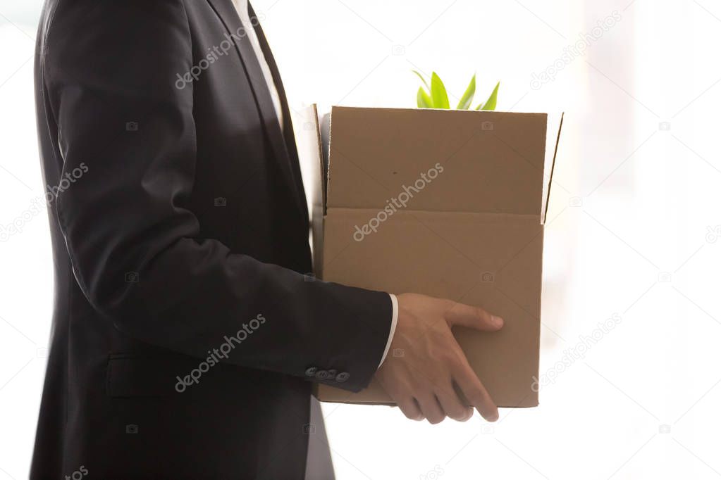 Close up of businessman holding box with personal belongings