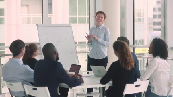 Diverse employees and female coach raise hands at business training — Stock Video