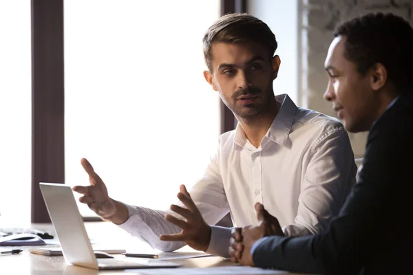 Diverse office workers sitting at workplace discussing working moments — Stock Photo, Image