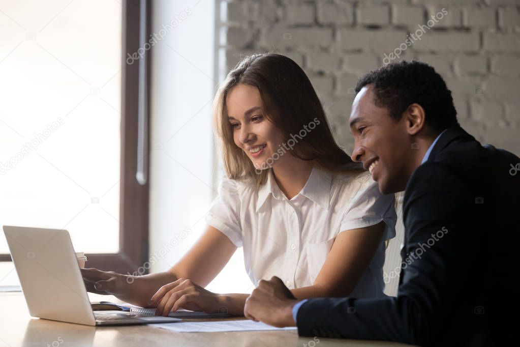 Female ceo advisor consulting african client looking at computer