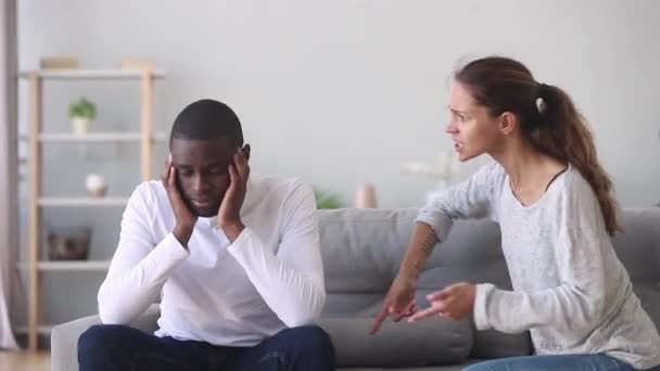 Frustrated african husband tired of annoying angry caucasian wife nagging — Stock Video