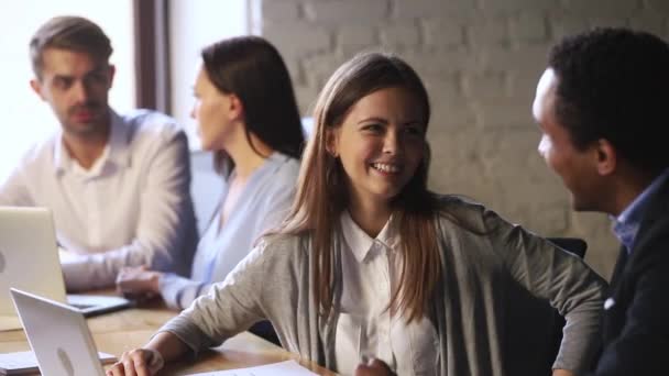 Friendly caucasian employee talking to african teammate laughing working together — Stock Video