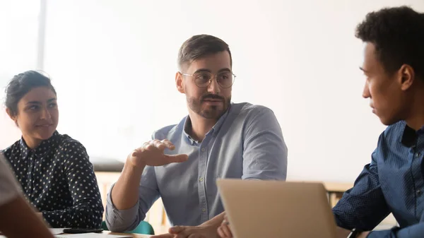 Diverse colleagues talk discussing ideas during meeting in office — Stock Photo, Image