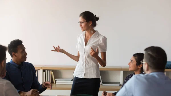 Confident businesswoman talk holding meeting with diverse colleagues — Stock Photo, Image