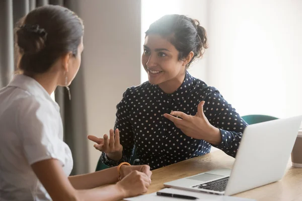 Excited diverse female colleagues discuss ideas at workplace — Stock Photo, Image
