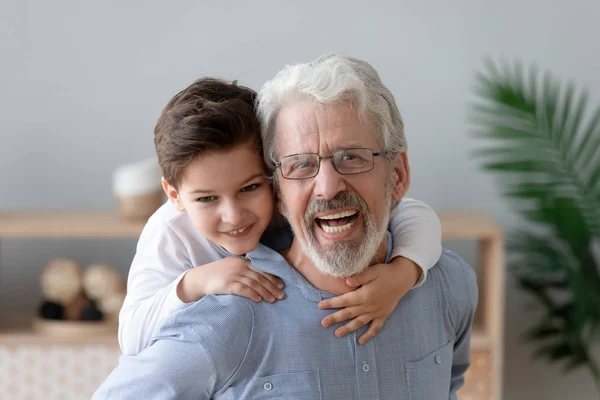 Portrait of happy grandson have fun piggyback smiling grandfather — Stock Photo, Image