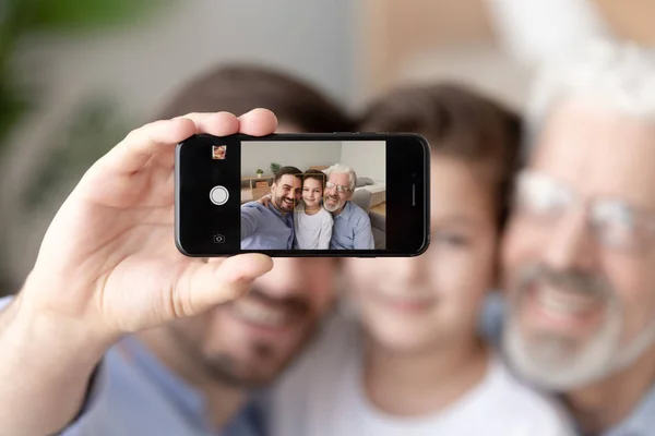 Smiling three generations of men take selfie on smartphone — Stock Photo, Image